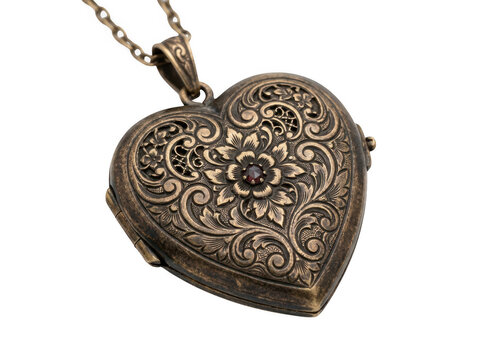 Intricate heart-shaped locket with detailed engravings and decorative patterns on a gold chain.