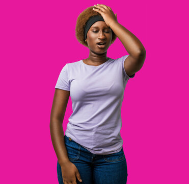 Young african american woman wearing pink clothes, hand on head after a mistake and error, forgot an important memory in studio