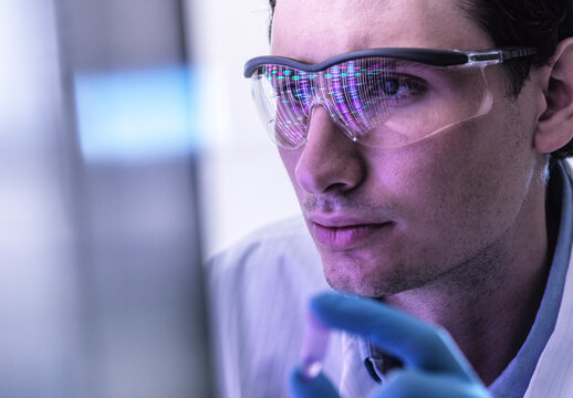 Scientist analyzes DNA sample in the biotechnology laboratory