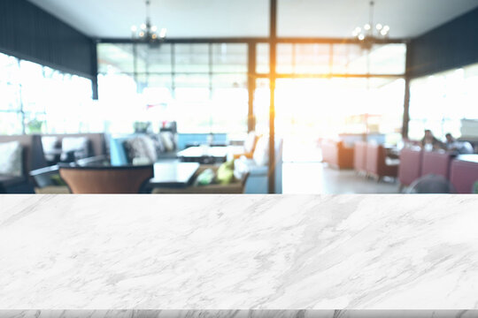 Minimalist abstract simple gentle light blur restaurant background on foreground marble for product presentation with light and beautiful shadow from window glass on wall and table.