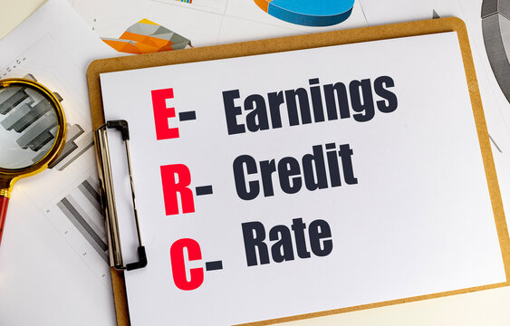 Credit rating concept with earning credit rate text on clipboard and financial charts