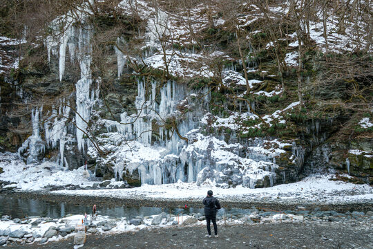 Misotsuchi Icicles in Otaki, Chichibu, Saitama Prefecture, Japan, featuring spectacular natural ice formations covering a rocky mountainside beside the Arakawa River. Snow-covered rocks.