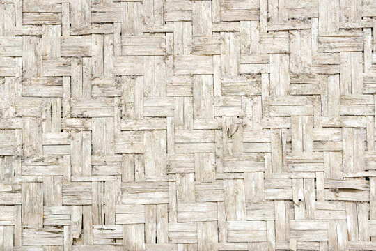 Traditional woven bamboo wall texture background, old weathered white bamboo weave pattern close up