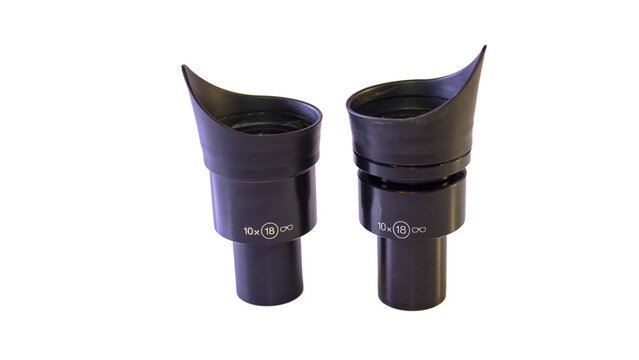Pair of 10x microscope eyepieces with black rubber eyecups, cylindrical housings and visible 18 mm field markings, isolated on a white background.