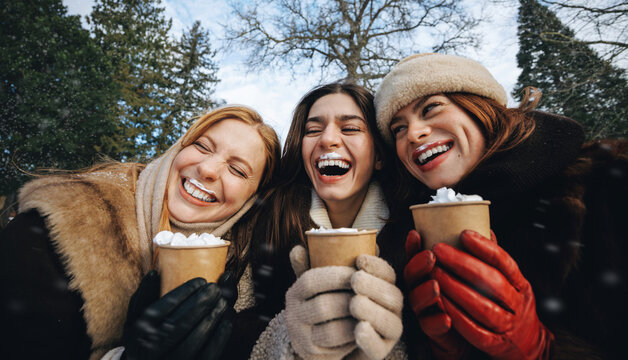 Best friend laughs with women over whipped cream drinks