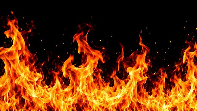 Bright orange fire flames burning with glowing sparks rising up on a dark black background