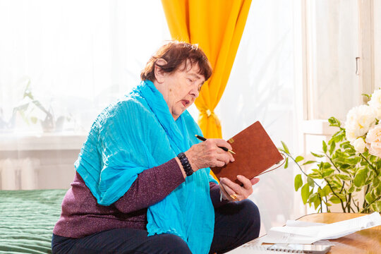 Elderly Caucasian woman planning future investments with paperwork and calculator. Focus and confidence. Concept of financial independence. Mid shot