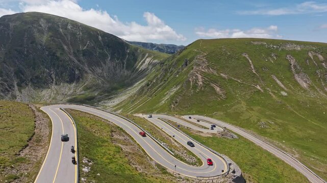Red Car Circling Transalpina Hairpin Road