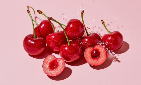  black cherries on a light pink background