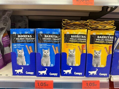 Mallorca, spain, october 07, 2026 compy cat treats displaying salmon, trout, chicken, and liver flavors on a supermarket shelf in calvia, spain