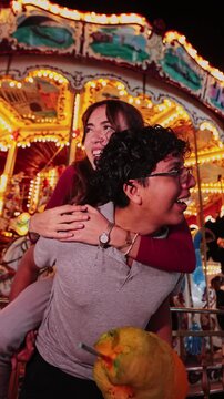 Happy young couple having fun at an amusement park