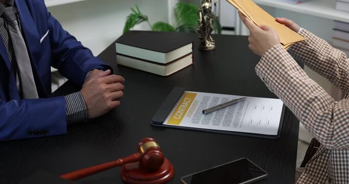 Legal consultation between a lawyer and a client, reviewing contract terms and discussing legal options to resolve disputes, protect rights, and make informed decisions.