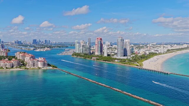 Landscape of Miami south beach. Yacht at sea. Aerial view on luxury charter yacht. Landscape aerial with Miami skyscraper. Luxury skyscraper in Miami south beach. Motorboat at sea. Pleasure boating