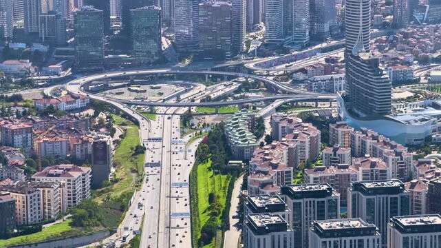 View of a busy highway and city buildings from above during the daytime