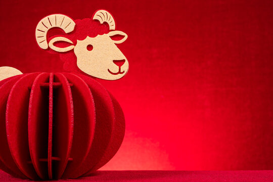 Red layered felt sheep lantern ornament for Chinese New Year on red background