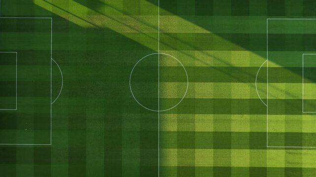 Aerial View of a Soccer Field With Shifting Shadows During the Day