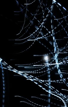 Abstract light trails on a black background with a motion blur effect. Neutral graphic background.