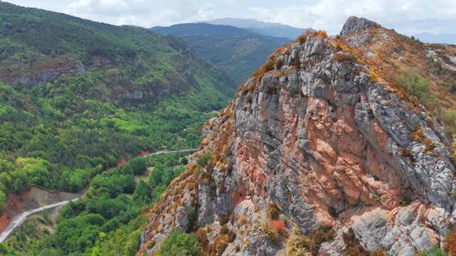 Aerial view of premature foliage yellowing and colorful dry mountain slopes due to severe heatwave near Ainsa, Pyrenees, Spain