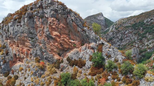 Aerial view of premature foliage yellowing and colorful dry mountain slopes due to severe heatwave near Ainsa, Pyrenees, Spain