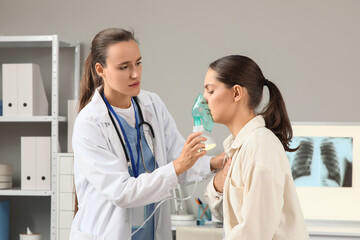 Obraz na płótnie Canvas Respiratory therapy and asthma treatment, doctor helping patient with nebulizer mask for breathing support in medical clinic office