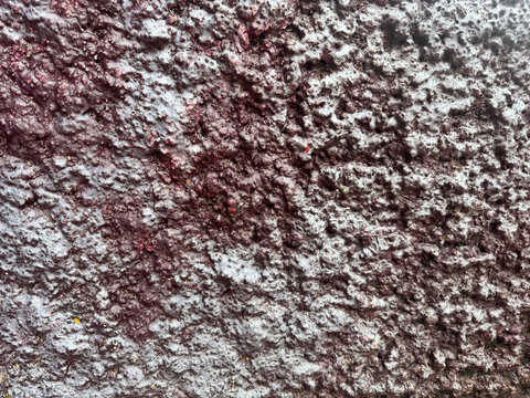 concrete wall texture coated with dark purple brown paint, abstract grunge background