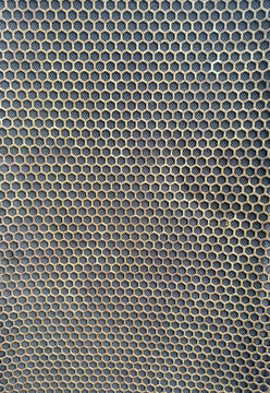 Vertical shot of rustic black speaker grill mesh with hexagonal pattern, abstract metal texture background