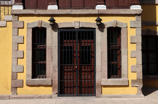 A traditional doorway and windows made of Sille stone in Konya. The walls of the 20th-century structure are painted yellow.