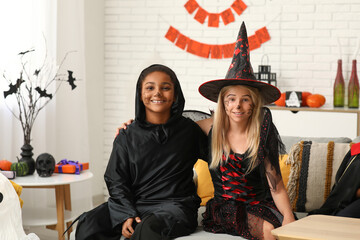 Fototapeta premium Halloween celebration, diverse children in costumes having fun at home party with festive decorations and face paint for trick or treat holiday event