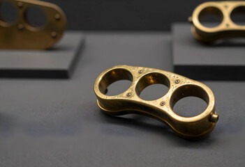 Fototapeta premium Violence and crime prevention, antique brass knuckle duster weapon on display in a museum exhibit for historical criminal justice and law enforcement