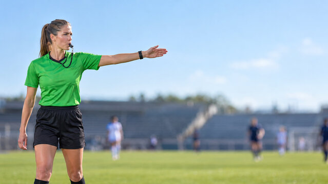 Female Soccer Referee in Green Uniform Pointing Her Arm to Signal a Decision on the Field. Concept of Fair Play, Sports Officiating, Authority, Rules, and Competitive Football Match