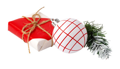 Fototapeta premium Gift wrapped in red with a white ornament and green foliage for Christmas celebration