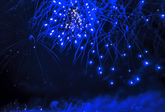 Colorful fireworks exploding over water at night