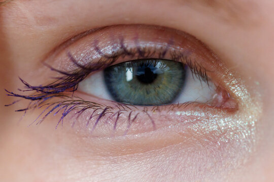 Close-up of human eye with green iris and dark pupil