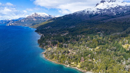 Fototapeta premium Villa Traful Lake Shoreline and Dense Andean Forests, Neuquén Province, Argentina, in Bright Daylight.