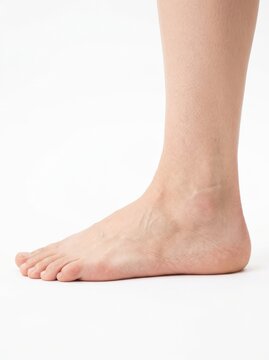 Side Profile of a Bare Human Foot and Ankle Isolated on White Background for Medical, Health, and Beauty Use