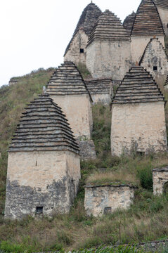  ancient, crumbling burial tower, a necropolis made of rough gray stone
