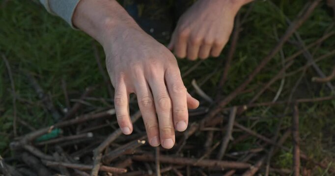 Close-up male hands break twigs, chop branches for firewood. 4K 10-b
