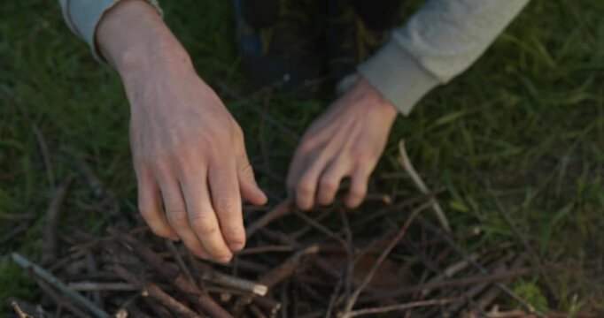 Close-up male hands break twigs, chop branches for firewood. 4K 10-b
