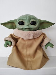 Naklejka premium Rome, Italy - October 9, 2026, Grogu, also known as Baby Yoda, a fictional character from the television series The Mandalorian, set in the Star Wars universe, displayed on a flatbed.