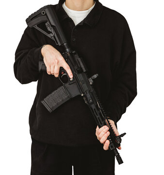 Man in black holding AR-15 tactical rifle across chest isolated on white background