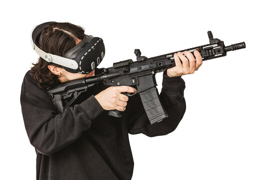 Man wearing virtual reality headset aiming AR-15 rifle controller in VR training simulation