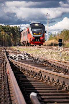 The modern "Orlan" diesel passenger train travels along the tracks, passing over a railway switch