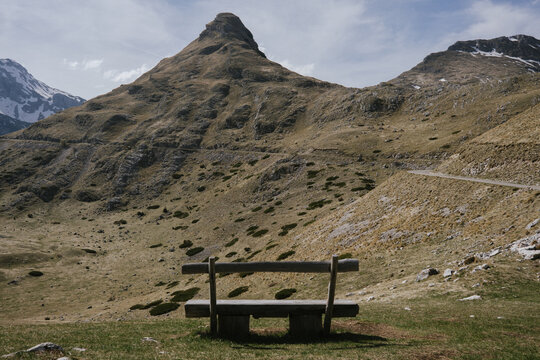 A solitary bench overlooking majestic mountains in Montenegro