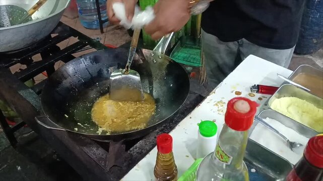 Indonesian Chef Cooking Authentic Nasi Goreng Kampung Fried Rice in Wok