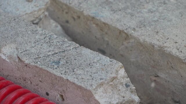 Jackhammer breaking solid concrete slab during street construction project. Close-up tracking shot.