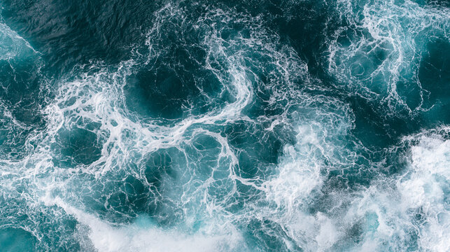 Aerial view of churning white sea foam on