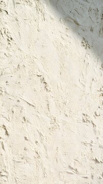 Rustic beige plaster wall with uneven hand textured surface