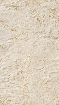 Rustic hand plastered beige wall with organic texture and shadows
