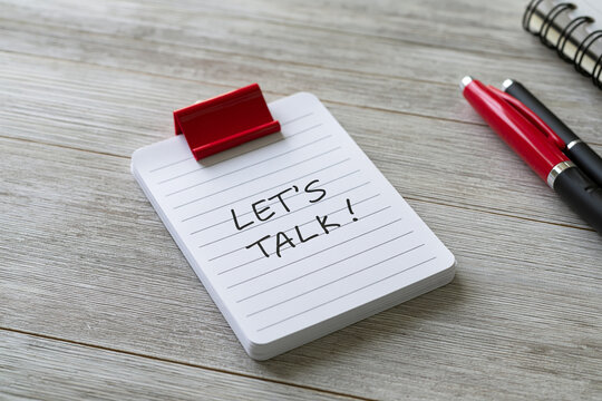 Red clip holding notes saying let us talk