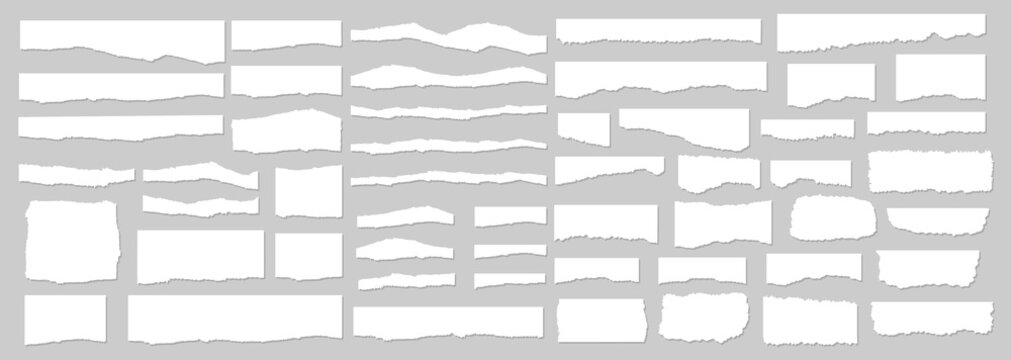 Collection of white torn paper strips on a gray background
